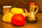 Closeup shot of loaves of bread, tomatoes, and a bottle of vinegar on a brown surface