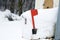 Closeup shot of a mailbox with a red lever covered with snow