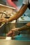 Closeup shot of male cook wearing protective gloves cleaning the raw pork under tap water for cooking