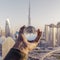 Closeup shot of a male hand holding a crystal ball with the reflection of the city