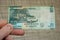 Closeup shot of a male hand holding Malawi 50 kwacha banknote