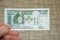 Closeup shot of a male hand holding Mongolian tugrik banknote