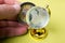 Closeup shot of a male holding a compass near a small glass globe