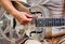 Closeup shot of a male playing the  silver iron guitar