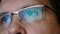 Closeup shot of man in glasses surfing internet