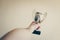 Closeup shot of a man holding a trophy behind the wall