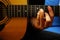 Closeup shot of a man playing guitar holding a barre chord