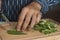 Closeup shot of man`s hand cutting okra