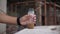 Closeup shot of a man\'s hand putting the plastic bottle filled with half coffee on the surface