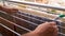 Closeup shot of a man\'s hands hanging wet clothes on the indoor metal drying rack