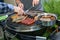 Closeup shot of Meat and sausages being fried on the grill