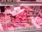 Closeup shot of the meat showcase in the supermarket. Raw meat