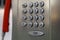 Closeup shot of a metal payphone keypad with red phone