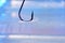 Closeup shot of a metal sharp hook on a water surface