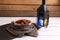 Closeup shot of Moroccan dates in white and orange bowl on a cloth on wooden background