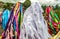 Closeup shot of multicolored lines of fabric hanging under a clouded sky