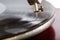 Closeup shot of a needle of the gramophone with a shellac disk