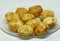 Closeup shot of newly cooked potato croquettes on a clear plate