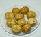 Closeup shot of newly cooked potato croquettes on a clear plate