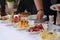 Closeup shot of nicely decorated appetizers with people being served