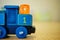 Closeup shot of a number blue toy train with an orange cube on it