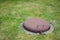 Closeup shot of an old closed hatch in a grass field