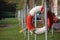 Closeup shot of an old lifebuoy hanging on a metal pipe outdoors