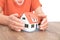 Closeup shot of old man`s hands pampering small house model on table