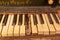 Closeup shot of an old piano keyboard with dusty damaged keys