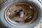 Closeup shot of an old and rusted car tire with spiderwebs on it