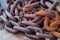 Closeup shot of old rusted chains on the ground