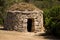 Closeup shot of an old stone shelter in a forest