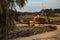 Closeup shot of an ongoing construction  with tracks and a bulldozer on an  abandoned land