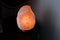 Closeup shot of an orange Himalayan salt light on the table