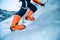 Closeup shot of an orange ice climbing boots with crampons  attached