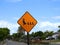 Closeup shot of an orange sign with ducks on it - caution sign