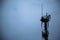 Closeup shot of overhead electric power lines with insulators in telecommunications tower