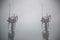 Closeup shot of overhead electric power lines with insulators in telecommunications towers