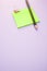 Closeup shot of the pencil on the notepad on the purple surface