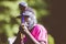 Closeup shot of a person aiming the paintball gun towards the camera with a blurred background