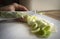 Closeup shot of a person cutting green scallions