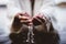 Closeup shot of a person drinking water with his hands with a blurred background