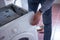 Closeup shot of a person fixing a laundry machine