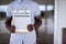 Closeup shot of a person holding up a volunteer sign up sheet with a blurred background