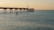 Closeup shot of a person paddleboarding over the water next to the dock