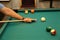 Closeup shot of a person playing billiards