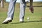 Closeup shot of a person reaching for a golf ball on a golf course