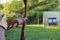 Closeup shot of a person shooting an arrow bow in a park