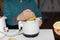 Closeup shot of a person squeezing lemon juice in the kitchen