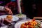 Closeup shot of a person taking a portion of food from the table